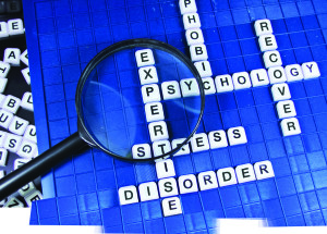 Psychology related words and magnifying glass on game board